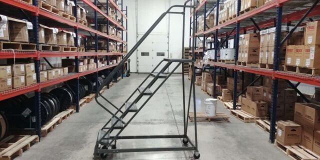 EGA Products Rolling Ladder between pallet racking with cardboard boxes